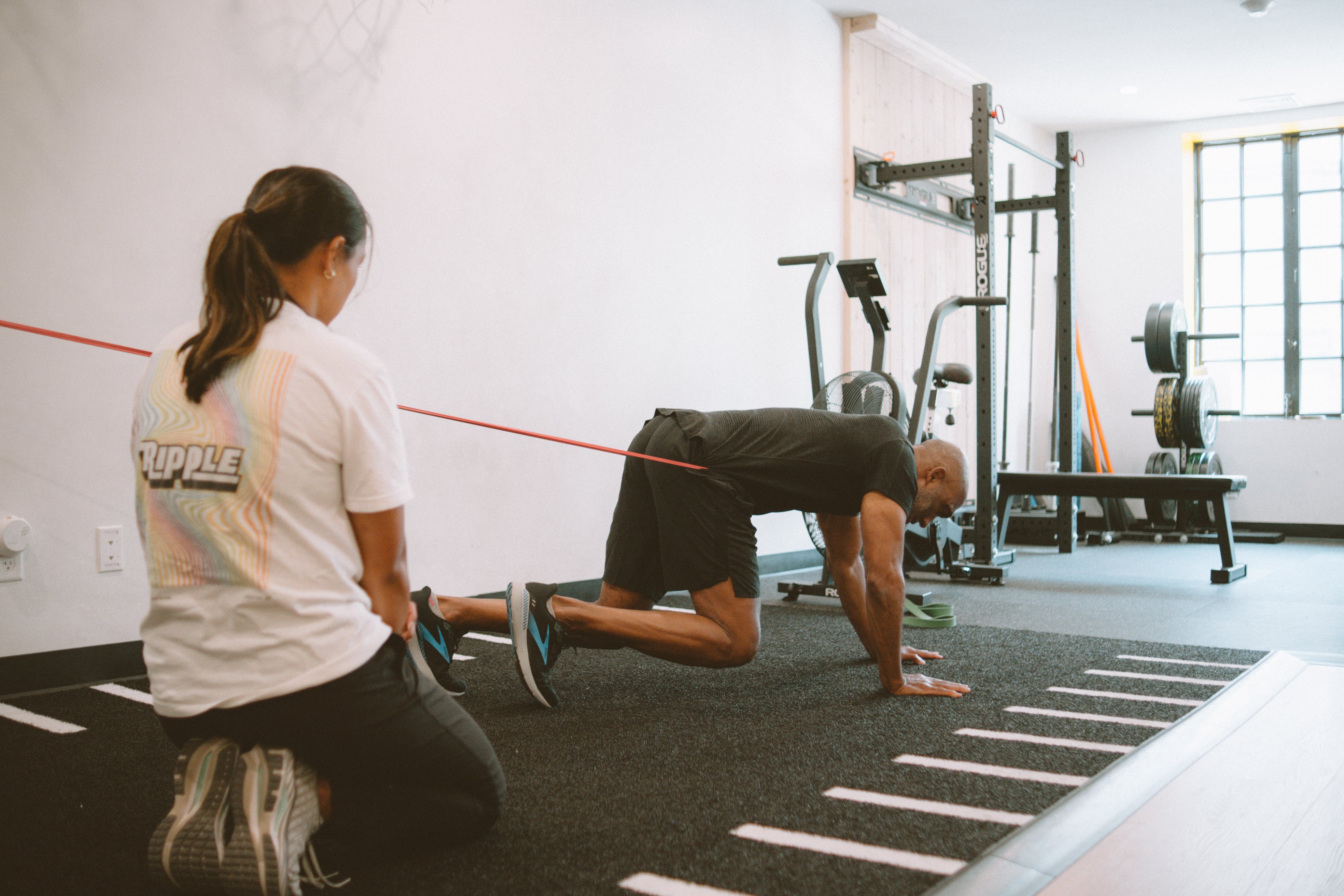 Physical therapist assisting a patient with a sports rehabilitation assessment