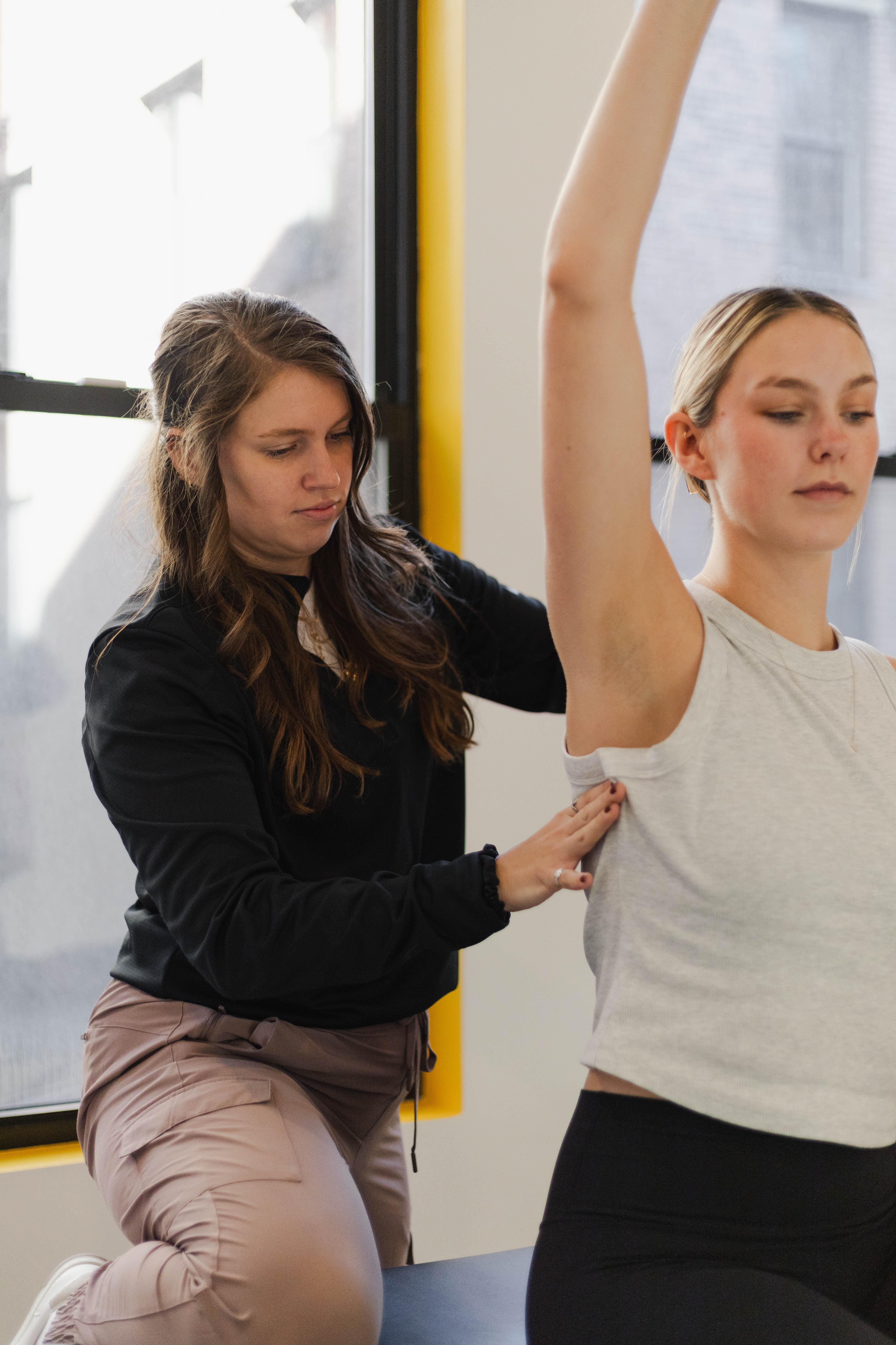 Physical therapist assisting a patient with a sports rehabilitation assessment